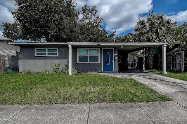 view of front facade with a carport and a front yard