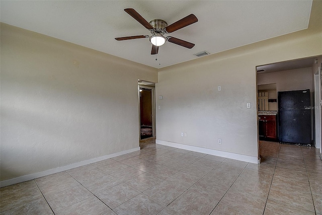 unfurnished room with light tile patterned floors and ceiling fan