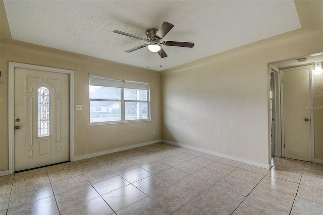 tiled foyer with a wealth of natural light, ceiling fan, and a textured ceiling