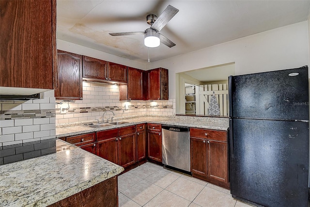 kitchen featuring black fridge, sink, light tile patterned floors, ceiling fan, and stainless steel dishwasher