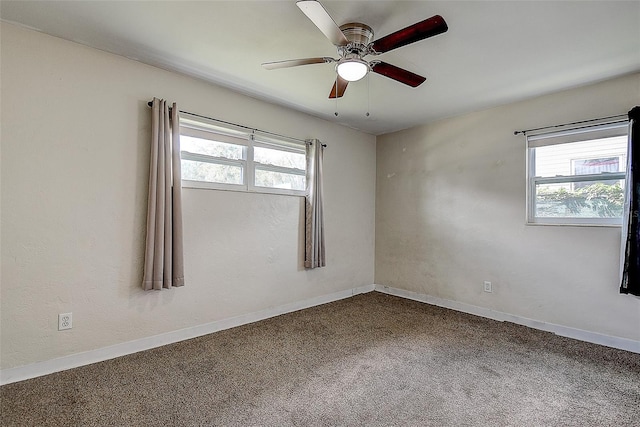 spare room featuring carpet and ceiling fan