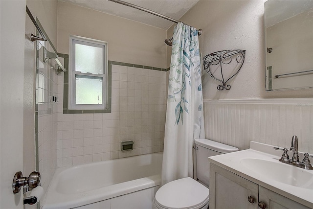 full bathroom featuring shower / bath combo, vanity, and toilet