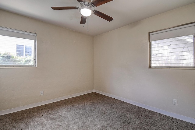 carpeted spare room featuring ceiling fan