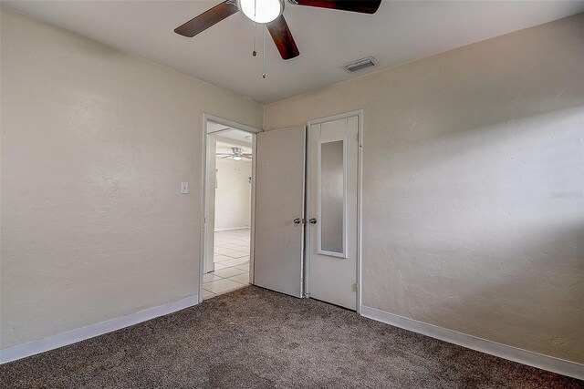 unfurnished bedroom with ceiling fan and light carpet