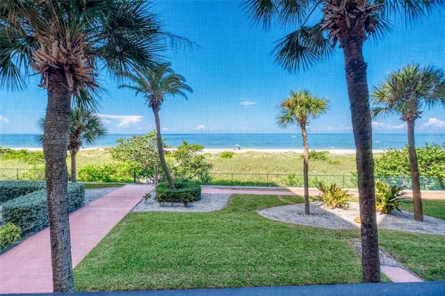 view of property's community with a yard and a water view