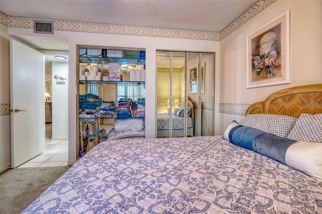 bedroom with light carpet, a textured ceiling, and a closet