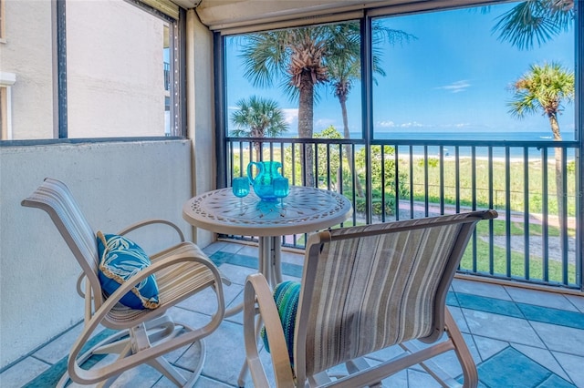 sunroom / solarium featuring a water view