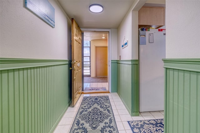 hall featuring light tile patterned floors