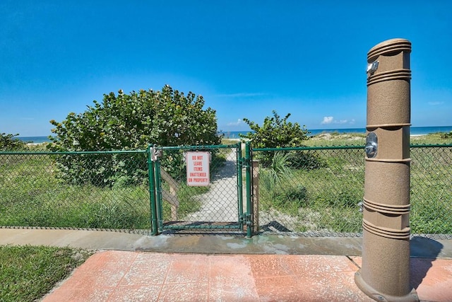 view of gate featuring a water view