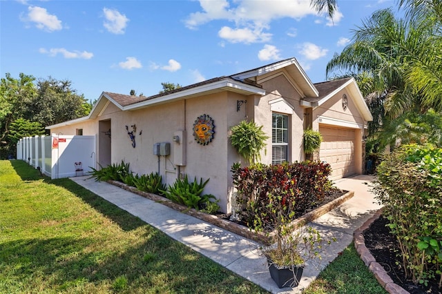 view of side of property with a yard and a garage