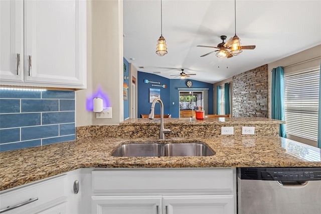 kitchen featuring ceiling fan, sink, stainless steel dishwasher, white cabinetry, and vaulted ceiling