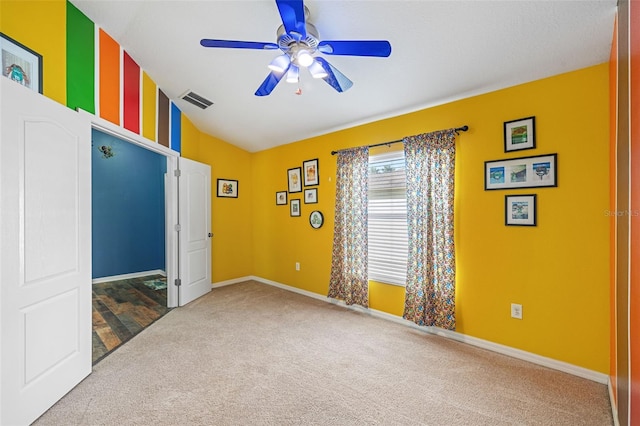 empty room featuring carpet and ceiling fan