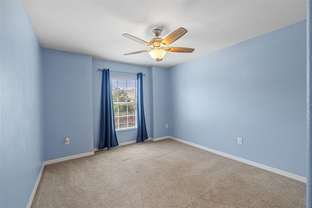 unfurnished room featuring a textured ceiling, carpet flooring, and ceiling fan