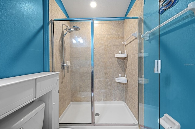 bathroom featuring walk in shower and toilet