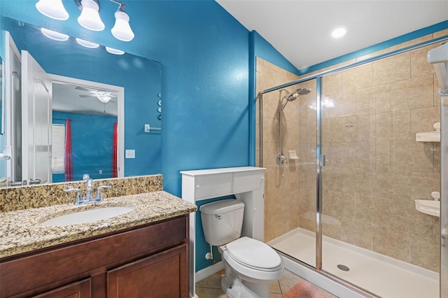 bathroom featuring a shower with shower door, vanity, tile patterned flooring, ceiling fan, and toilet