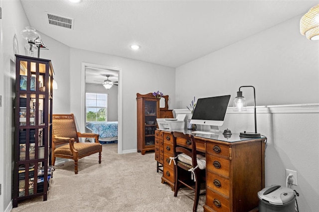 home office with light carpet and ceiling fan