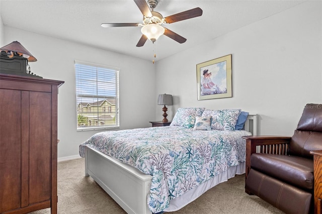 bedroom featuring ceiling fan and light colored carpet