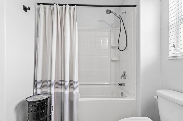 bathroom featuring shower / bath combination with curtain and toilet