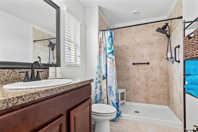 bathroom featuring vanity, tile patterned flooring, toilet, a textured ceiling, and walk in shower