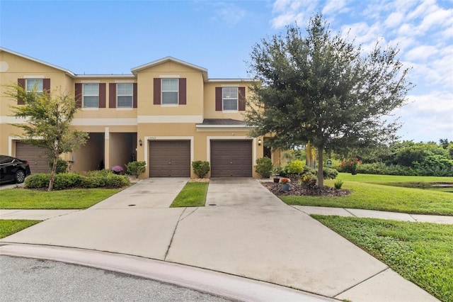 multi unit property featuring a front yard and a garage