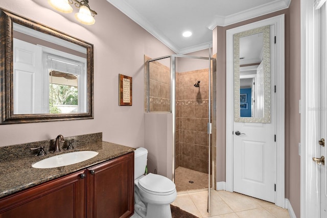 full bathroom featuring vanity, crown molding, toilet, tile patterned floors, and a stall shower