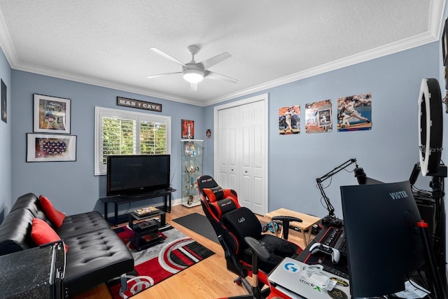 office featuring crown molding, wood finished floors, and a ceiling fan