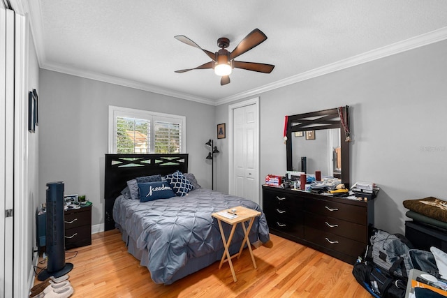 bedroom featuring light wood-style flooring and crown molding