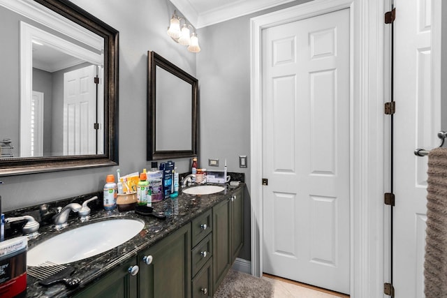 bathroom featuring double vanity, crown molding, tile patterned flooring, and a sink