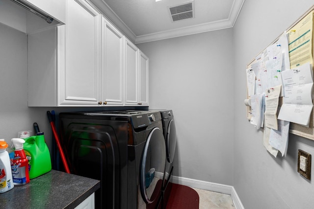clothes washing area with baseboards, visible vents, washer and dryer, cabinet space, and ornamental molding