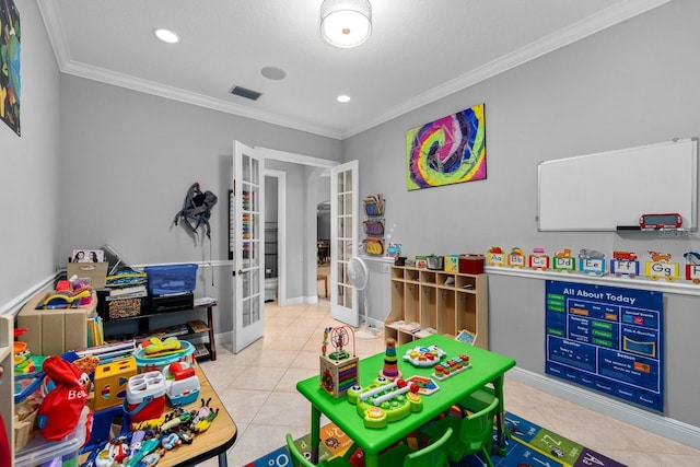 recreation room featuring french doors, tile patterned floors, crown molding, and visible vents