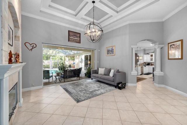 living area featuring decorative columns, ornamental molding, light tile patterned flooring, arched walkways, and a towering ceiling