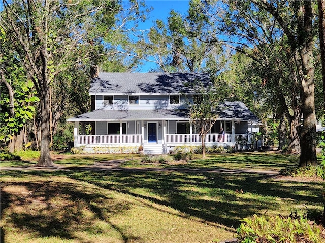 farmhouse with a porch and a front lawn