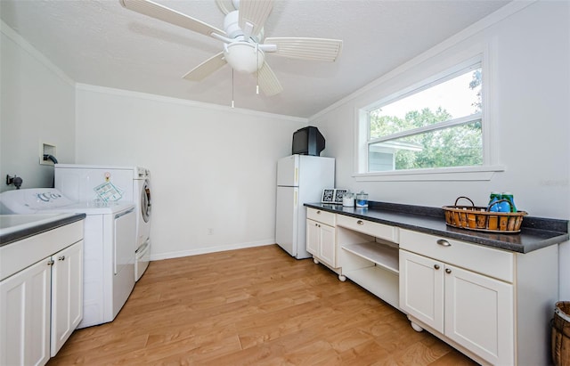 laundry room with cabinets, crown molding, ceiling fan, separate washer and dryer, and light hardwood / wood-style floors