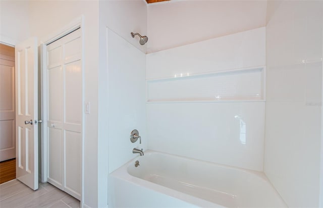 bathroom featuring shower / tub combination and hardwood / wood-style flooring