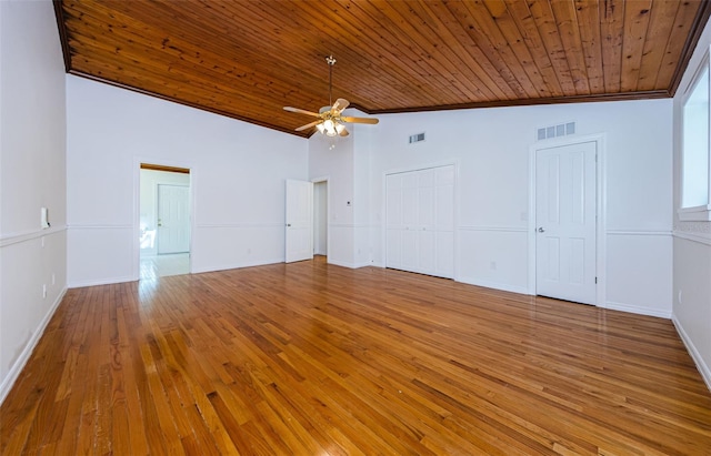 interior space with ceiling fan, hardwood / wood-style floors, wooden ceiling, and lofted ceiling