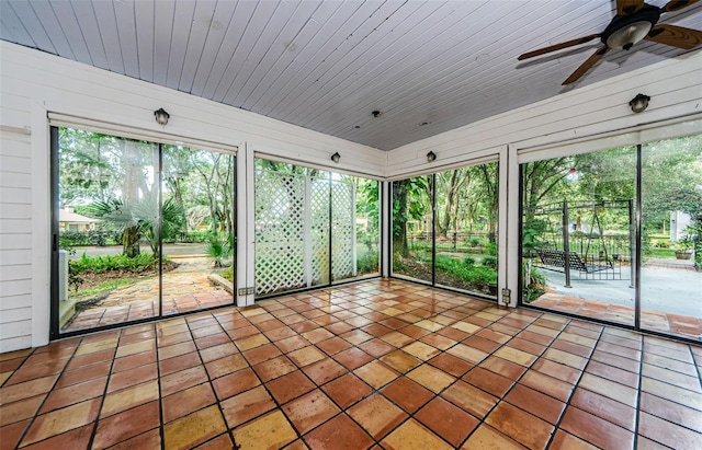 unfurnished sunroom with ceiling fan and a wealth of natural light