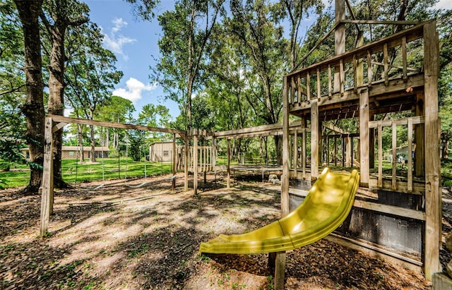 view of playground featuring an outbuilding