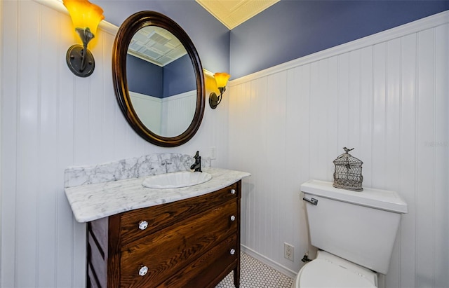bathroom featuring vanity, baseboards, and toilet
