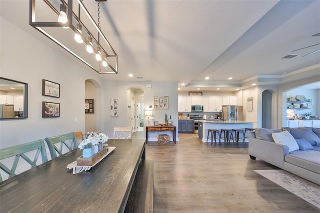 dining room with an inviting chandelier and wood-type flooring