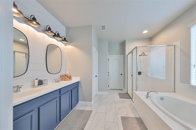 bathroom with independent shower and bath and vanity