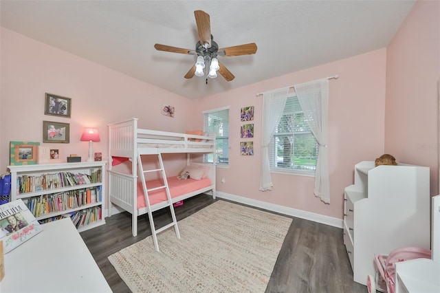 bedroom with dark hardwood / wood-style flooring and ceiling fan