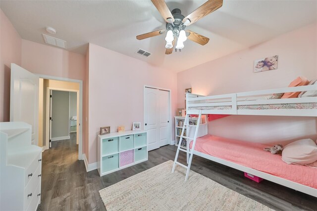 bedroom with ceiling fan, a closet, and dark hardwood / wood-style flooring