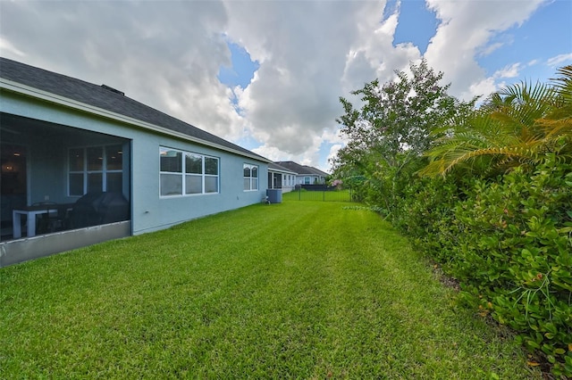 view of yard featuring a sunroom and cooling unit