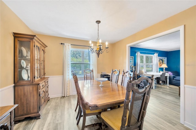 dining space featuring a chandelier, light hardwood / wood-style floors, and a healthy amount of sunlight