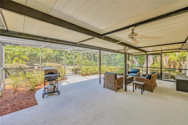 sunroom / solarium with ceiling fan and beamed ceiling