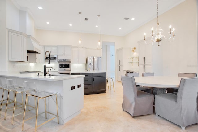 kitchen with stainless steel appliances, light countertops, visible vents, and tasteful backsplash