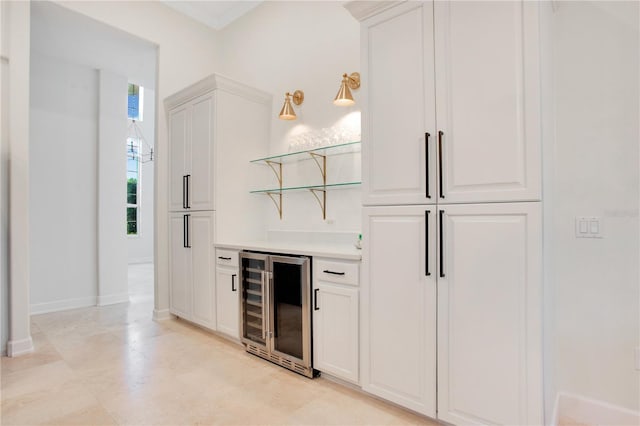 bar with wine cooler, a dry bar, and baseboards