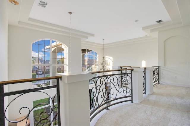 hall featuring a chandelier, carpet flooring, an upstairs landing, and visible vents