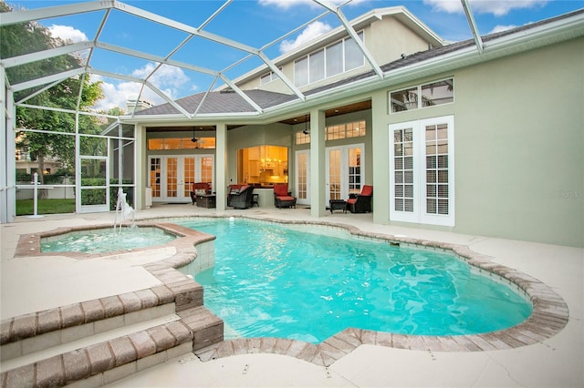 pool with glass enclosure, ceiling fan, an in ground hot tub, french doors, and a patio area