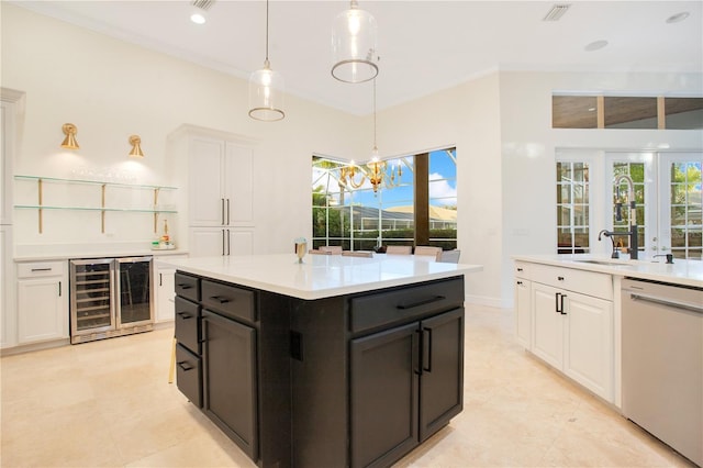 kitchen featuring light countertops, dishwasher, wine cooler, white cabinetry, and decorative light fixtures